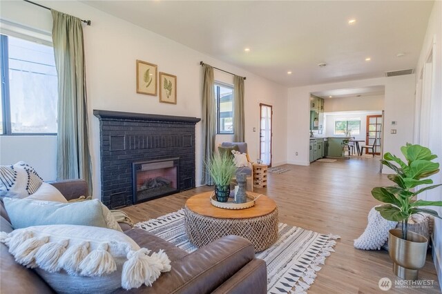 5502 Chuckanut Dr, Bow, WA 98232 - living area featuring plenty of natural light, wood finished floors, a fireplace, and recessed lighting