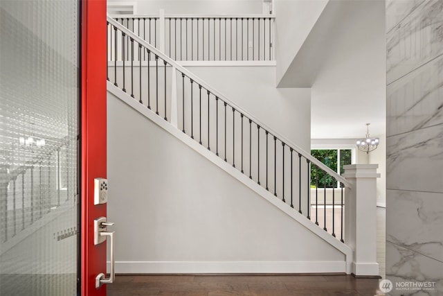 587 155th Pl NE, Bellevue, WA 98007 - stairs with a towering ceiling, wood finished floors, and a chandelier