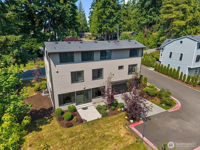 587 155th Pl NE, Bellevue, WA 98007 - rear view of property featuring a patio area, driveway, and a yard