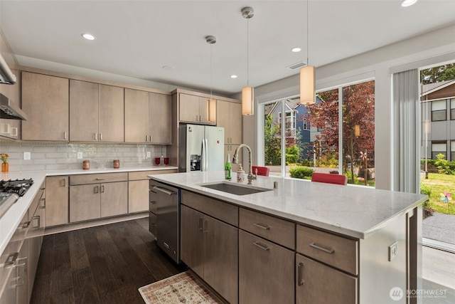 587 155th Pl NE, Bellevue, WA 98007 - kitchen with stainless steel appliances, dark wood finished floors, light stone counters, decorative backsplash, and recessed lighting