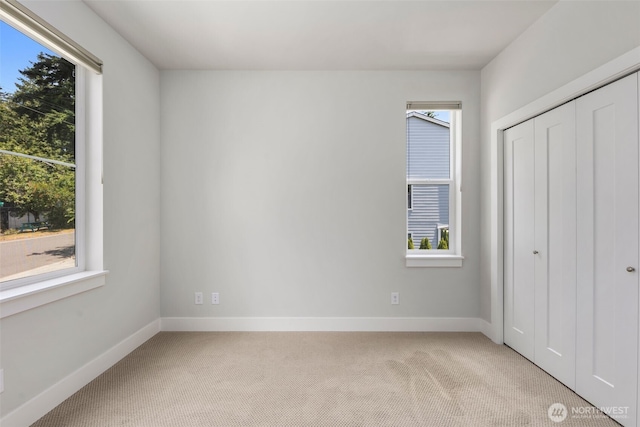 587 155th Pl NE, Bellevue, WA 98007 - unfurnished bedroom featuring light carpet and a closet