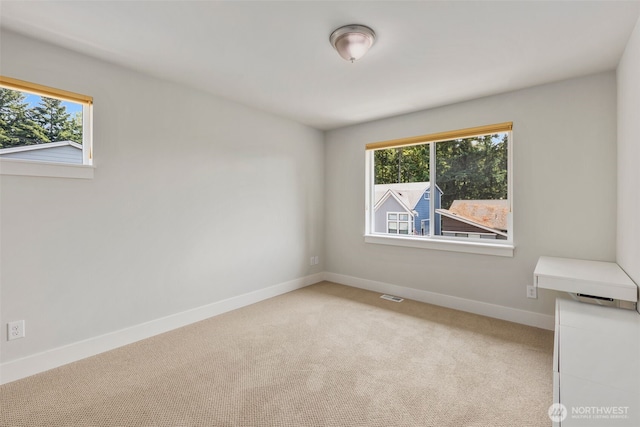 587 155th Pl NE, Bellevue, WA 98007 - spare room with baseboards and light carpet