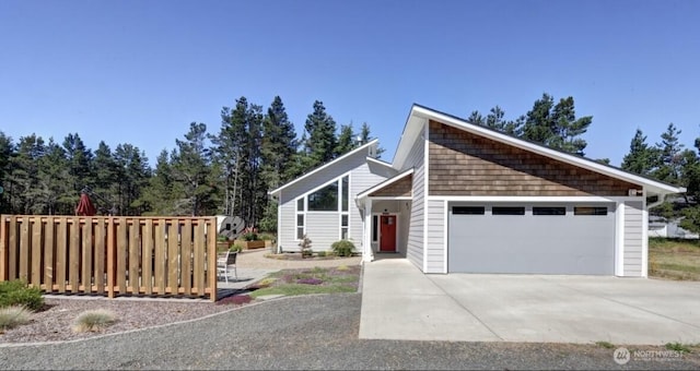 999 41st Ln, Seaview, WA 98644 - mid-century modern home featuring concrete driveway and an attached garage