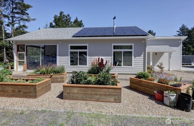 999 41st Ln, Seaview, WA 98644 - rear view of property with a garden and roof mounted solar panels