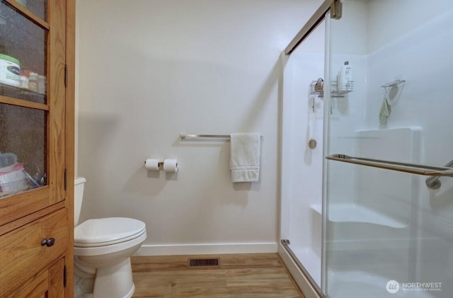 999 41st Ln, Seaview, WA 98644 - bathroom featuring wood finished floors and a stall shower