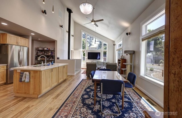 999 41st Ln, Seaview, WA 98644 - dining area featuring high vaulted ceiling, plenty of natural light, ceiling fan, and light wood-style floors