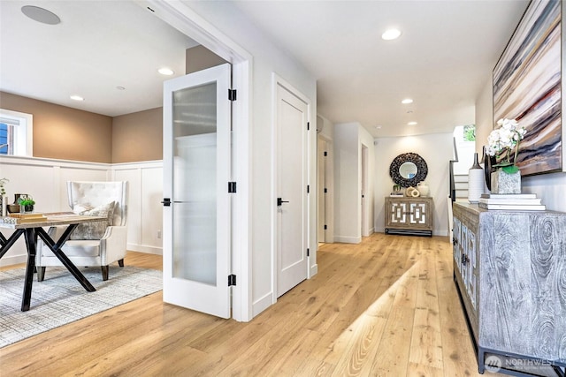 11216 NE 67th St Unit 4, Kirkland, WA 98033 - corridor featuring light wood-style floors, a wainscoted wall, recessed lighting, and a decorative wall