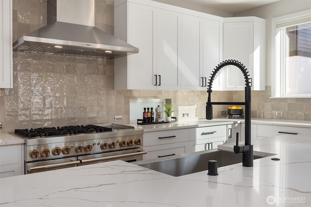 11216 NE 67th St Unit 4, Kirkland, WA 98033 - kitchen with wall chimney range hood, double oven range, tasteful backsplash, and white cabinetry