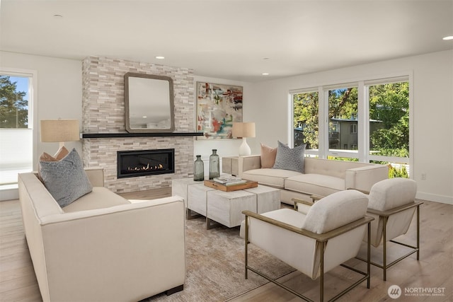 11216 NE 67th St Unit 4, Kirkland, WA 98033 - living area with wood finished floors, plenty of natural light, a tiled fireplace, and recessed lighting