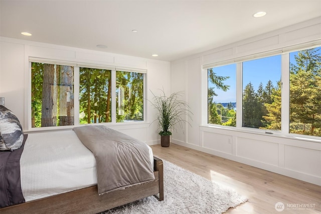 11216 NE 67th St Unit 4, Kirkland, WA 98033 - bedroom with wood finished floors, a decorative wall, and recessed lighting