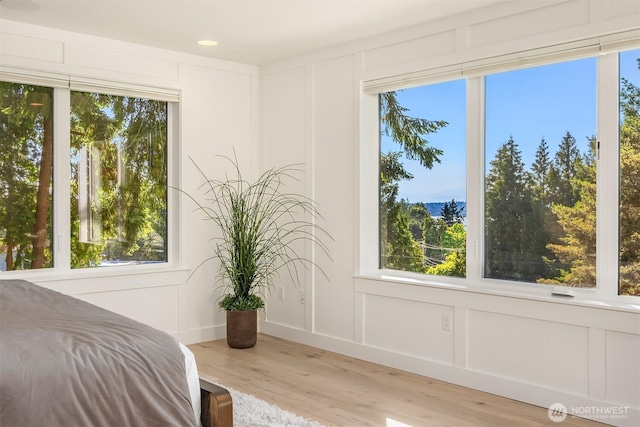 11216 NE 67th St Unit 4, Kirkland, WA 98033 - bedroom with a decorative wall, wood finished floors, multiple windows, and recessed lighting