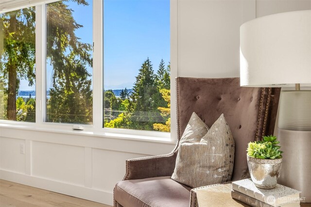 11216 NE 67th St Unit 4, Kirkland, WA 98033 - sitting room with wood finished floors, healthy amount of natural light, and a decorative wall