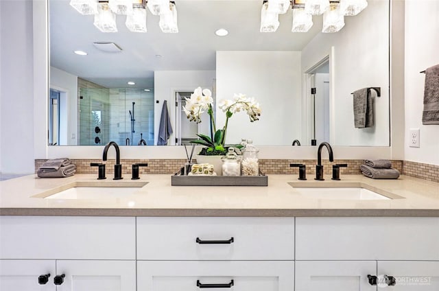 11216 NE 67th St Unit 4, Kirkland, WA 98033 - bathroom featuring double vanity, backsplash, a shower stall, a chandelier, and recessed lighting