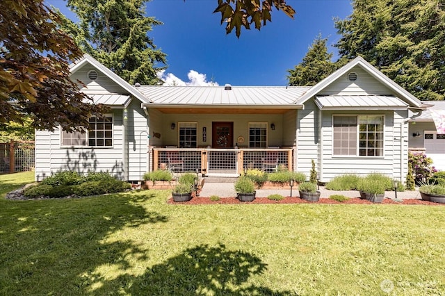 1043 NE Pennington Loop, Coupeville, WA 98239 - view of front of home featuring a standing seam roof, a porch, a front lawn, and a metal roof
