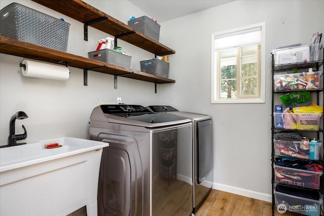 1043 NE Pennington Loop, Coupeville, WA 98239 - washroom featuring washing machine and dryer and light wood-style floors
