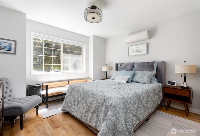 1043 NE Pennington Loop, Coupeville, WA 98239 - bedroom featuring an AC wall unit and wood finished floors