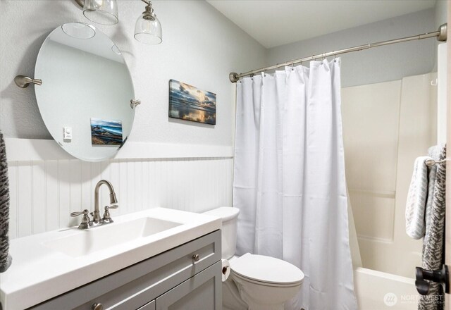 1043 NE Pennington Loop, Coupeville, WA 98239 - bathroom featuring wainscoting, vanity, and shower / tub combo