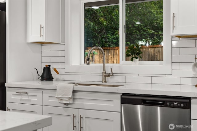 10403 Wauna St SW, Lakewood, WA 98498 - kitchen featuring stainless steel dishwasher, backsplash, white cabinets, and light stone counters