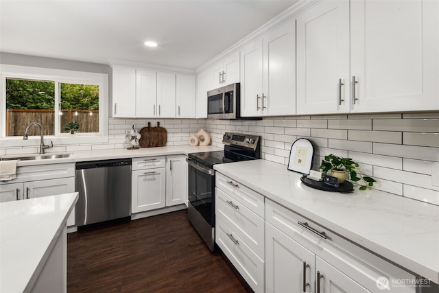 10403 Wauna St SW, Lakewood, WA 98498 - kitchen featuring appliances with stainless steel finishes, tasteful backsplash, white cabinets, recessed lighting, and dark wood-type flooring