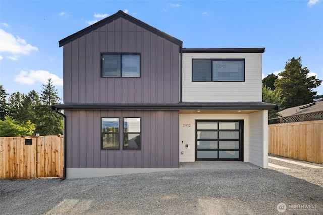 2912 SW Thistle St Unit B, Seattle, WA 98126 - view of front of house with a garage, driveway, and board and batten siding