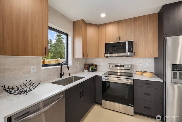 2912 SW Thistle St Unit B, Seattle, WA 98126 - kitchen featuring appliances with stainless steel finishes, light countertops, decorative backsplash, and recessed lighting