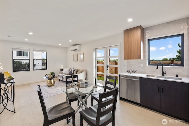 2912 SW Thistle St Unit B, Seattle, WA 98126 - kitchen with stainless steel dishwasher, an AC wall unit, light countertops, healthy amount of natural light, and recessed lighting