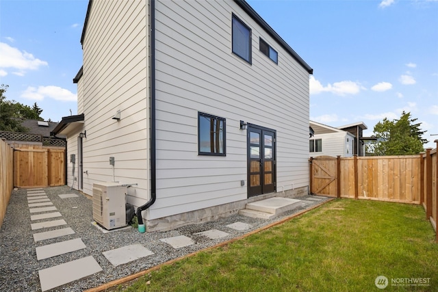 2912 SW Thistle St Unit B, Seattle, WA 98126 - rear view of house with french doors, a fenced backyard, and a gate