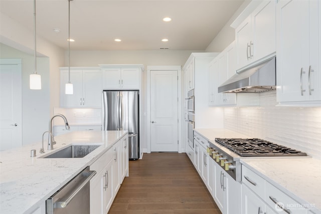 1297 Westridge Way NE, Issaquah, WA 98029 - kitchen with appliances with stainless steel finishes, under cabinet range hood, recessed lighting, white cabinets, and pendant lighting