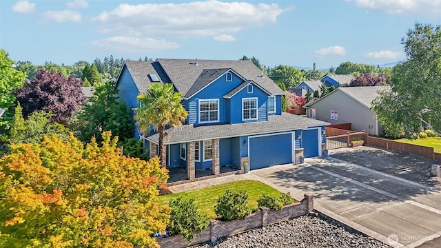 10400 NE 197th St, Battle Ground, WA 98604 - view of front of house featuring driveway, a shingled roof, and a garage