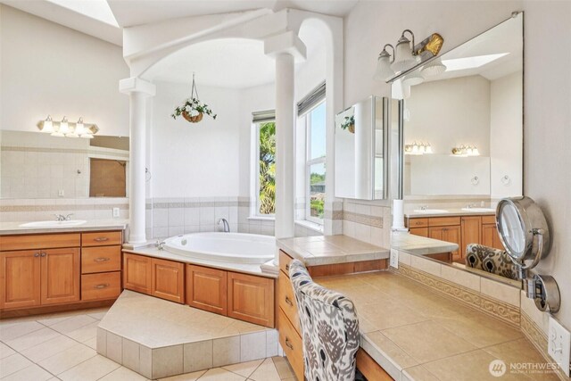 10400 NE 197th St, Battle Ground, WA 98604 - full bath featuring decorative columns, a bath, two vanities, and tile patterned flooring