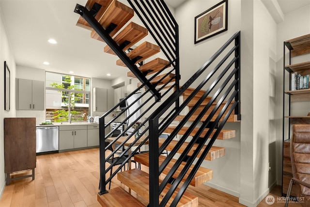 3019 62nd Ave SW Unit D, Seattle, WA 98116 - staircase with wood finished floors and recessed lighting