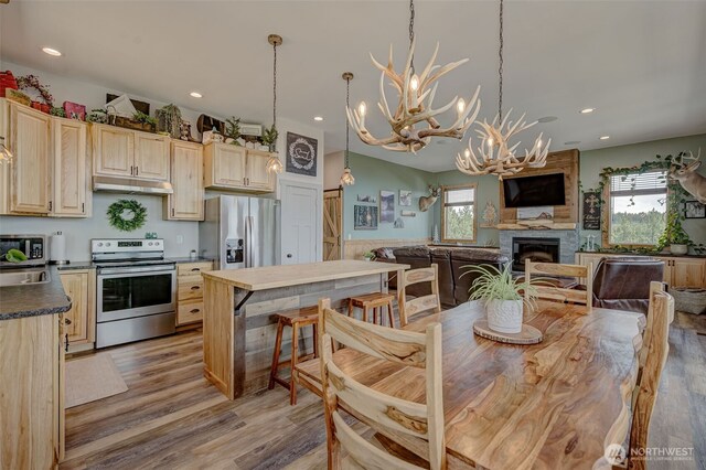 108 Hummingbird Rd, East Wenatchee, WA 98802 - dining space featuring healthy amount of natural light, a chandelier, light wood finished floors, recessed lighting, and a large fireplace