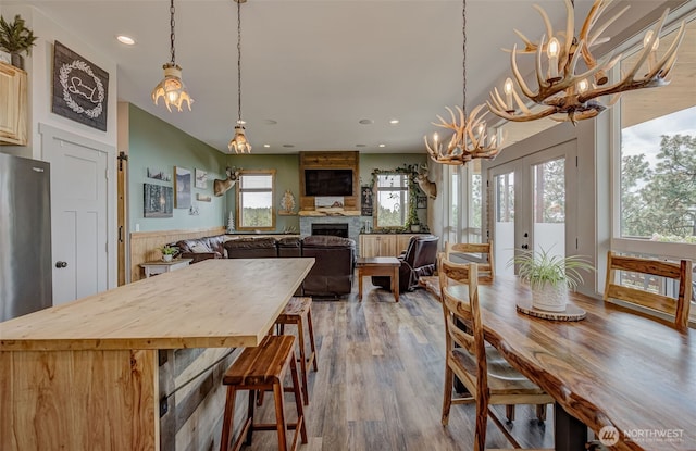 108 Hummingbird Rd, East Wenatchee, WA 98802 - dining area with a chandelier, a fireplace, recessed lighting, and wood finished floors