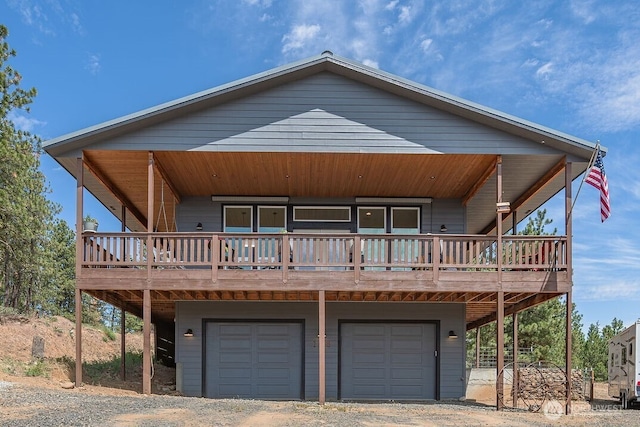 108 Hummingbird Rd, East Wenatchee, WA 98802 - view of front of house with a wooden deck, dirt driveway, and an attached garage