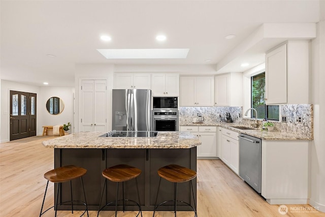 9019 166th St E, Puyallup, WA 98375 - kitchen featuring appliances with stainless steel finishes, decorative backsplash, plenty of natural light, white cabinetry, and recessed lighting