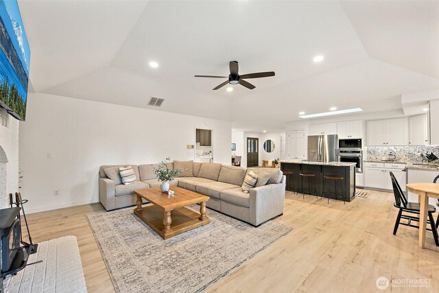 9019 166th St E, Puyallup, WA 98375 - living area featuring ceiling fan, light wood finished floors, recessed lighting, and a raised ceiling