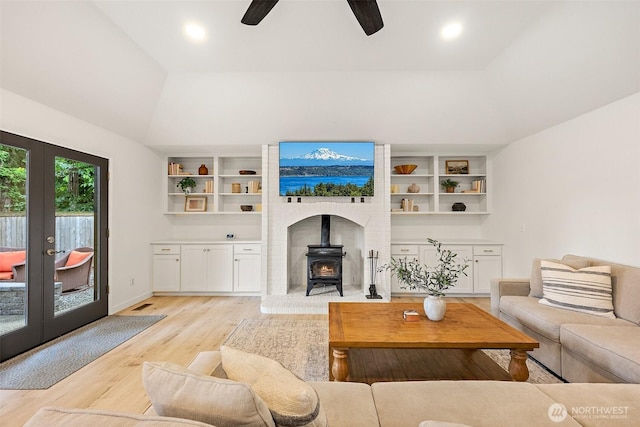 9019 166th St E, Puyallup, WA 98375 - living room featuring a wood stove, light wood finished floors, french doors, a ceiling fan, and recessed lighting