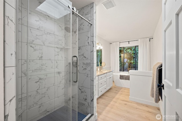 9019 166th St E, Puyallup, WA 98375 - bathroom with a marble finish shower, vanity, wood finished floors, and a freestanding tub