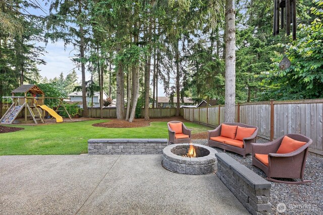 9019 166th St E, Puyallup, WA 98375 - fenced backyard featuring an outdoor fire pit, a patio, and a playground