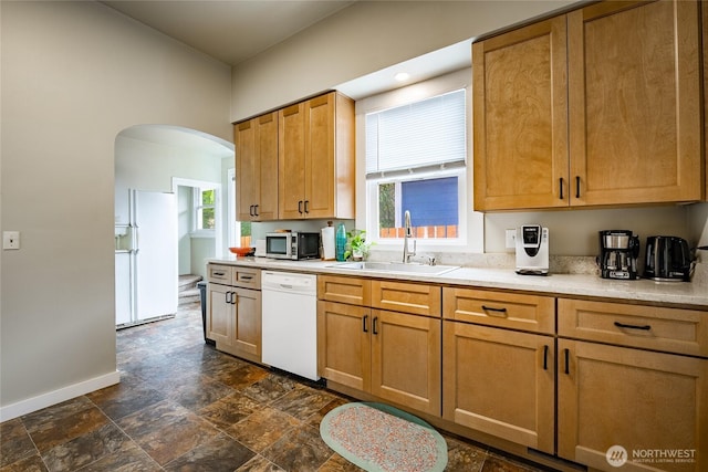 1639 King St, Bellingham, WA 98225 - kitchen with white appliances, light countertops, arched walkways, and dark stone finish floors