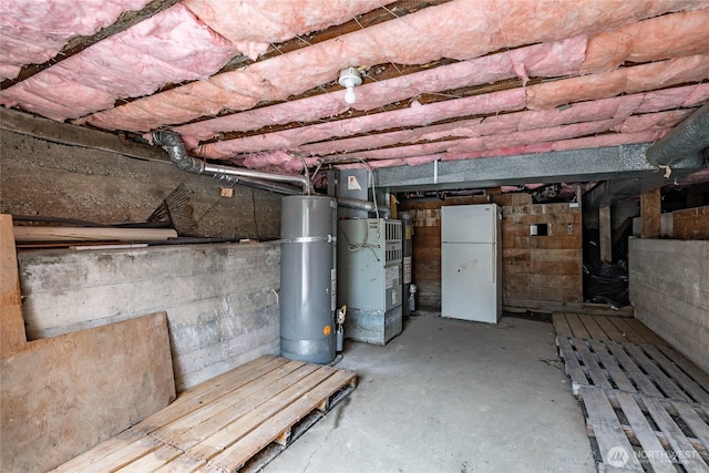 1639 King St, Bellingham, WA 98225 - unfinished below grade area featuring freestanding refrigerator, strapped water heater, and heating unit