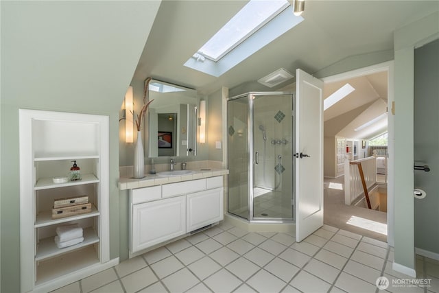 6306 17th Ave NE, Seattle, WA 98115 - bathroom with vaulted ceiling, a skylight, vanity, a shower stall, and tile patterned flooring