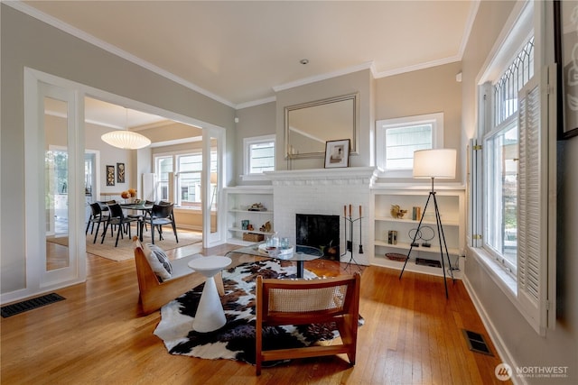 6306 17th Ave NE, Seattle, WA 98115 - living area featuring hardwood / wood-style floors, healthy amount of natural light, crown molding, and a fireplace
