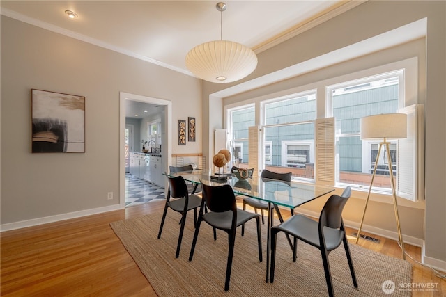 6306 17th Ave NE, Seattle, WA 98115 - dining space featuring ornamental molding and light wood-style floors