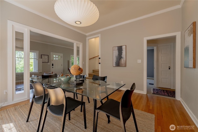 6306 17th Ave NE, Seattle, WA 98115 - dining space featuring light wood finished floors, crown molding, and stairs