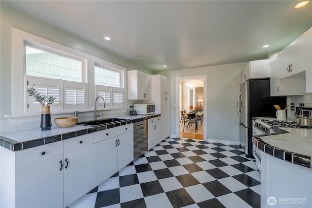 6306 17th Ave NE, Seattle, WA 98115 - kitchen with tile countertops, white microwave, dark flooring, dishwasher, and white cabinets