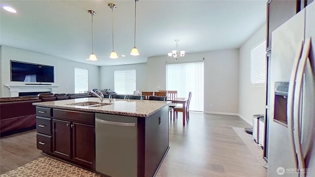 4218 SW Colbert Way, Port Orchard, WA 98367 - kitchen featuring appliances with stainless steel finishes, light wood-style flooring, a chandelier, dark brown cabinets, and open floor plan