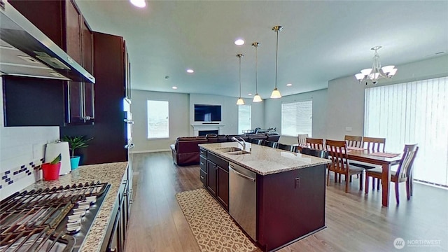 4218 SW Colbert Way, Port Orchard, WA 98367 - kitchen featuring ventilation hood, stainless steel appliances, open floor plan, light wood-type flooring, and a chandelier