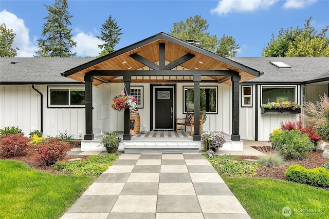 1317 23rd Ave SW, Puyallup, WA 98371 - view of front facade with covered porch, roof with shingles, and board and batten siding