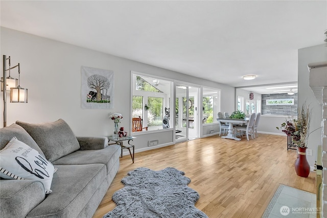 1317 23rd Ave SW, Puyallup, WA 98371 - living area featuring light wood-type flooring and baseboards